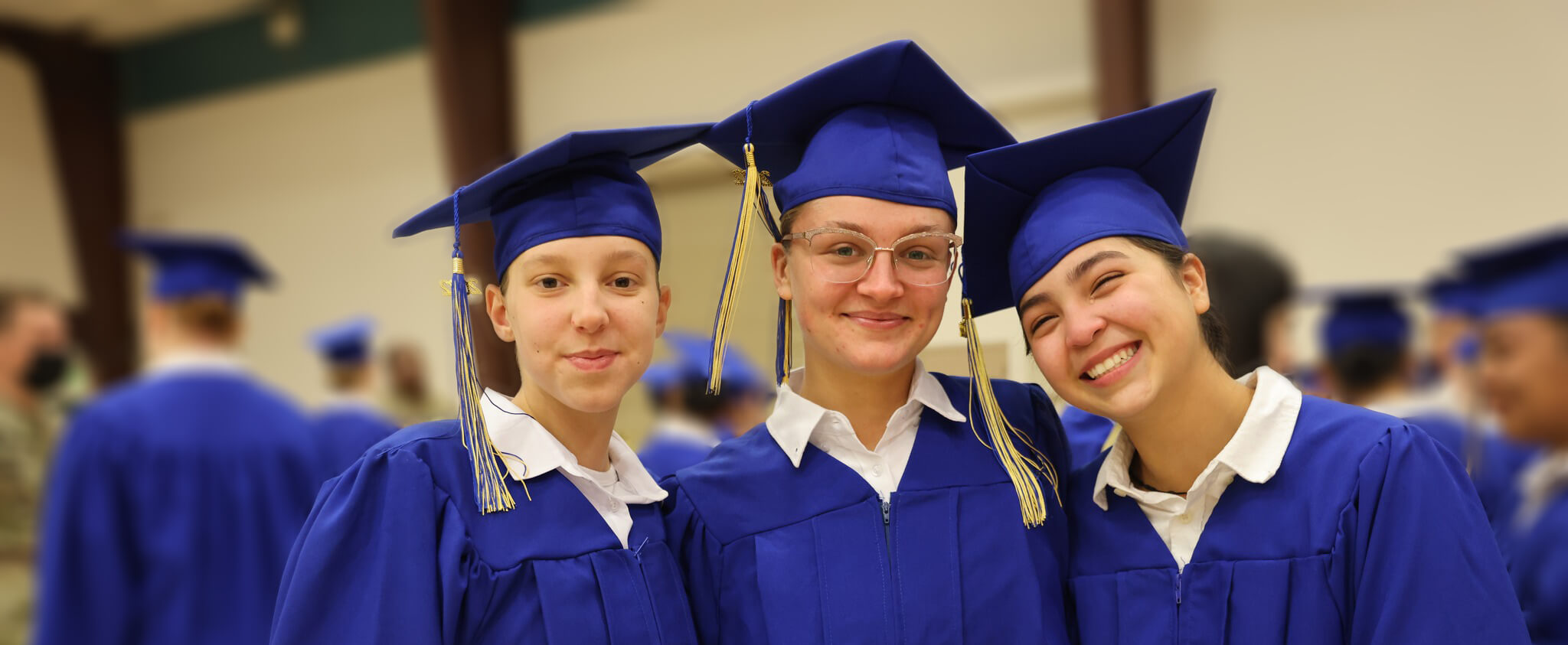 female trio smiling blur 850x350